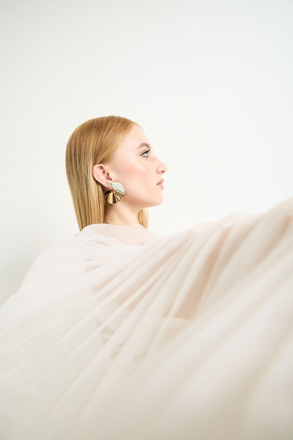 Side profile of a model wearing the Summer statement earrings by By Odara